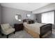 Cozy bedroom featuring a wood-framed bed, carpet, and a round mirror at 13777 W Amherst Way, Lakewood, CO 80228