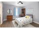 Cozy bedroom with blue walls, a ceiling fan, a dinosaur-themed bed spread, and wood floors at 13777 W Amherst Way, Lakewood, CO 80228