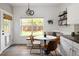 Charming breakfast nook featuring built-in bench seating, a round table, and bright natural light at 13777 W Amherst Way, Lakewood, CO 80228