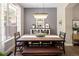 Elegant dining room featuring a modern chandelier, a rustic dining table and large windows at 13777 W Amherst Way, Lakewood, CO 80228
