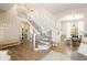 Spacious foyer with a staircase, opening to a dining area and living spaces with wood-look floors at 13777 W Amherst Way, Lakewood, CO 80228