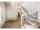 Grand foyer boasting a soaring ceiling, elegant staircase with metal railing, and wood-look flooring at 13777 W Amherst Way, Lakewood, CO 80228
