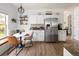 Eat-in kitchen with breakfast nook and stainless steel refrigerator, complemented by white cabinets and granite countertops at 13777 W Amherst Way, Lakewood, CO 80228