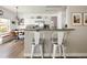 Open-concept kitchen with granite breakfast bar and seating, overlooking the breakfast nook at 13777 W Amherst Way, Lakewood, CO 80228