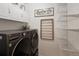 Laundry room offers shelving and white cabinets above a modern washer and dryer at 13777 W Amherst Way, Lakewood, CO 80228