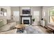 Living room showcases a fireplace, large windows, and a comfortable seating arrangement with stylish decor at 13777 W Amherst Way, Lakewood, CO 80228