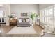 Bright living room featuring neutral decor, stylish furnishings, and ample natural light at 13777 W Amherst Way, Lakewood, CO 80228