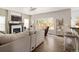 Comfortable living room features a fireplace, large window, and view into kitchen with bar seating at 13777 W Amherst Way, Lakewood, CO 80228