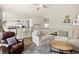 Open-concept living room with kitchen view, comfortable seating, and abundant natural light at 13777 W Amherst Way, Lakewood, CO 80228