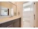 Stylish bathroom featuring a grey vanity, modern fixtures, and an open doorway to the tub at 427 Milwaukee St, Denver, CO 80206