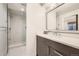 Modern bathroom with walk-in shower and sleek vanity with stainless fixtures at 427 Milwaukee St, Denver, CO 80206