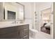 Contemporary bathroom featuring modern vanity, toilet, and open doorway to bedroom at 427 Milwaukee St, Denver, CO 80206