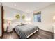Bedroom with stylish gray bedding, recessed lights, and a window with privacy blind at 427 Milwaukee St, Denver, CO 80206