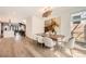 Bright dining room featuring a modern chandelier, wood table and flooring, and an eye-catching horse art piece at 427 Milwaukee St, Denver, CO 80206