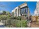 Modern two-story home with a combination of white stone and wood-paneled accents at 427 Milwaukee St, Denver, CO 80206