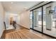 Bright hallway with hardwood floors, leading to a balcony with sliding glass doors and views at 427 Milwaukee St, Denver, CO 80206
