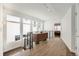 Modern hallway with hardwood floors, large windows, metal railing, and accent furniture at 427 Milwaukee St, Denver, CO 80206