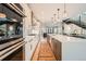 Spacious kitchen with stainless steel appliances, sleek cabinetry, large central island and decorative tile backsplash at 427 Milwaukee St, Denver, CO 80206