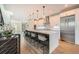 Bright kitchen featuring a large island with seating, stainless steel appliances, and modern pendant lighting fixtures at 427 Milwaukee St, Denver, CO 80206