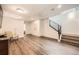 Modern living room with hardwood floors, ceiling fan, and stairway with metal railing at 427 Milwaukee St, Denver, CO 80206