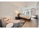 Relaxing main bedroom suite with hardwood floors, plush seating area, and ample natural light from surrounding windows at 427 Milwaukee St, Denver, CO 80206