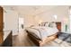 Bright main bedroom featuring a unique wooden bed frame, modern lighting, and access to the rest of the home at 427 Milwaukee St, Denver, CO 80206