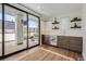 Stylish wet bar area with stainless steel mini fridge and view to the patio with a hot tub at 427 Milwaukee St, Denver, CO 80206