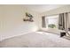 Sunny bedroom with neutral walls, carpet flooring, and a view at 1148 Opal St # 101, Broomfield, CO 80020