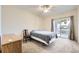 Bright bedroom with sliding glass doors leading to the private balcony at 1148 Opal St # 101, Broomfield, CO 80020