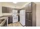 Efficient kitchen with appliances, granite countertops, and ample cabinet space at 1148 Opal St # 101, Broomfield, CO 80020