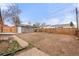 Expansive backyard featuring a pergola, mature trees, and ample room for landscaping at 2713 S Hazel Ct, Denver, CO 80236