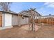 Backyard featuring a pergola with a brick base and a detached garage at 2713 S Hazel Ct, Denver, CO 80236