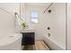 A modern bathroom with clean lines, white tiles, and black fixtures at 2713 S Hazel Ct, Denver, CO 80236