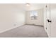 Inviting bedroom with soft carpet, a large window, and neutral decor at 2713 S Hazel Ct, Denver, CO 80236