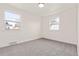 Cozy bedroom with neutral carpet and two windows providing natural light at 2713 S Hazel Ct, Denver, CO 80236