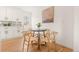 Cozy dining area off the kitchen with a modern round table and natural light at 2713 S Hazel Ct, Denver, CO 80236