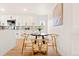 Kitchen dining area includes a round table and decorative art on a white wall at 2713 S Hazel Ct, Denver, CO 80236