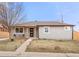 Charming single-story home with a cozy front porch and manicured lawn at 2713 S Hazel Ct, Denver, CO 80236