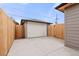 Backyard featuring a detached garage and a concrete parking area at 2713 S Hazel Ct, Denver, CO 80236