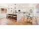 Bright kitchen features a large island with seating and modern lighting fixtures at 2713 S Hazel Ct, Denver, CO 80236
