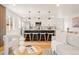 Open concept kitchen and living room with modern island and seating, hardwood floors at 2713 S Hazel Ct, Denver, CO 80236