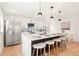 The kitchen has an island with barstool seating and stainless steel appliances at 2713 S Hazel Ct, Denver, CO 80236