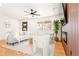 Bright living room featuring hardwood floors, fireplace, wood paneling, and plenty of light at 2713 S Hazel Ct, Denver, CO 80236