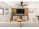 Bright and modern living room with wood-paneled wall, fireplace, and hardwood floors at 2713 S Hazel Ct, Denver, CO 80236