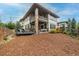 Expansive backyard with a patio, outdoor seating, mature trees, and privacy fencing at 5420 Baseline Rd, Boulder, CO 80303