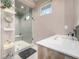 Modern bathroom featuring a glass enclosed shower, white countertop, and floating wooden shelves at 5420 Baseline Rd, Boulder, CO 80303