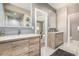 Elegant bathroom featuring double sinks with wood cabinets and a view of the main bedroom at 5420 Baseline Rd, Boulder, CO 80303