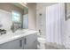 Updated bathroom featuring modern vanity, shower over tub with white tile surround, and ample lighting at 5420 Baseline Rd, Boulder, CO 80303