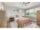Comfortable bedroom with natural light, neutral color scheme, ceiling fan, and plush bedding at 5420 Baseline Rd, Boulder, CO 80303