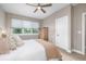 Bedroom with neutral walls, ceiling fan, plush bedding, lots of natural light and a great view at 5420 Baseline Rd, Boulder, CO 80303